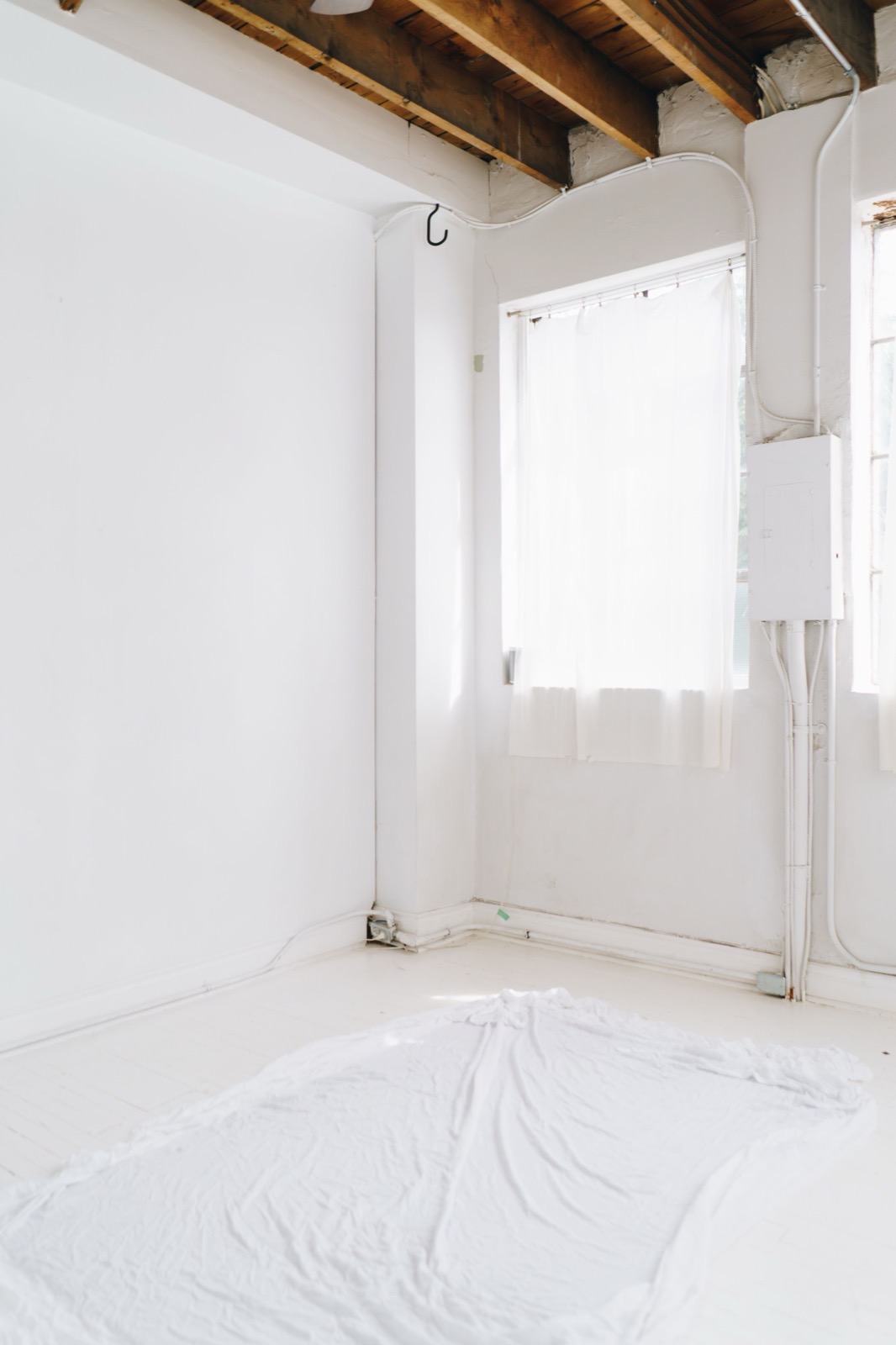 A freshly painted room with sheets folded and surfaces cleaned