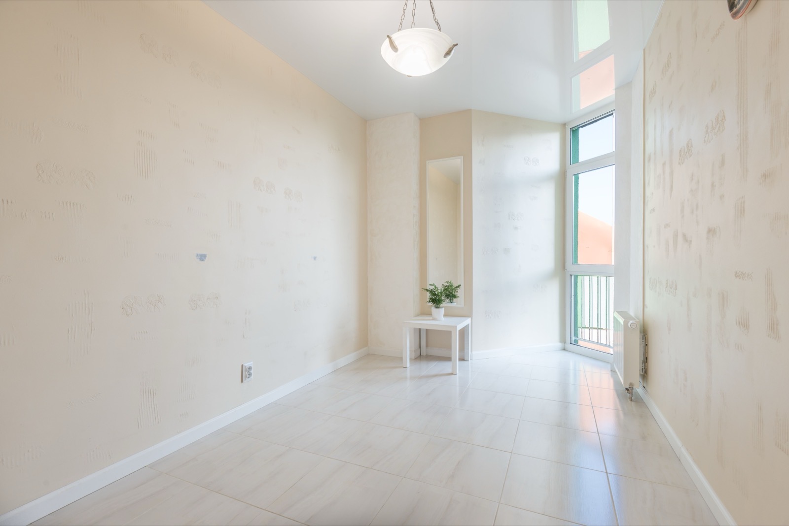 Living room before painting — marked walls and tired woodwork
