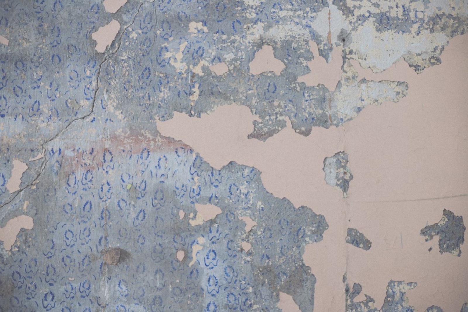 Bedroom wallpaper before stripping — peeling and mismatched